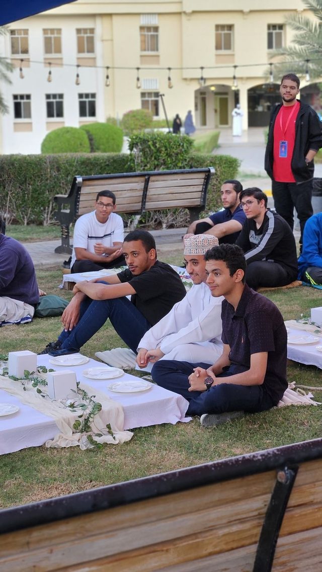 Students sitting together on the lawn at the 2024 orientation day